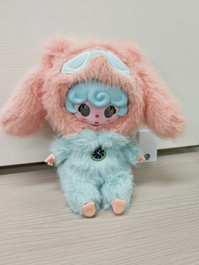 Seated AI character — pink and aqua