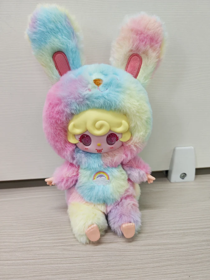 Seated AI character — rainbow bunny
