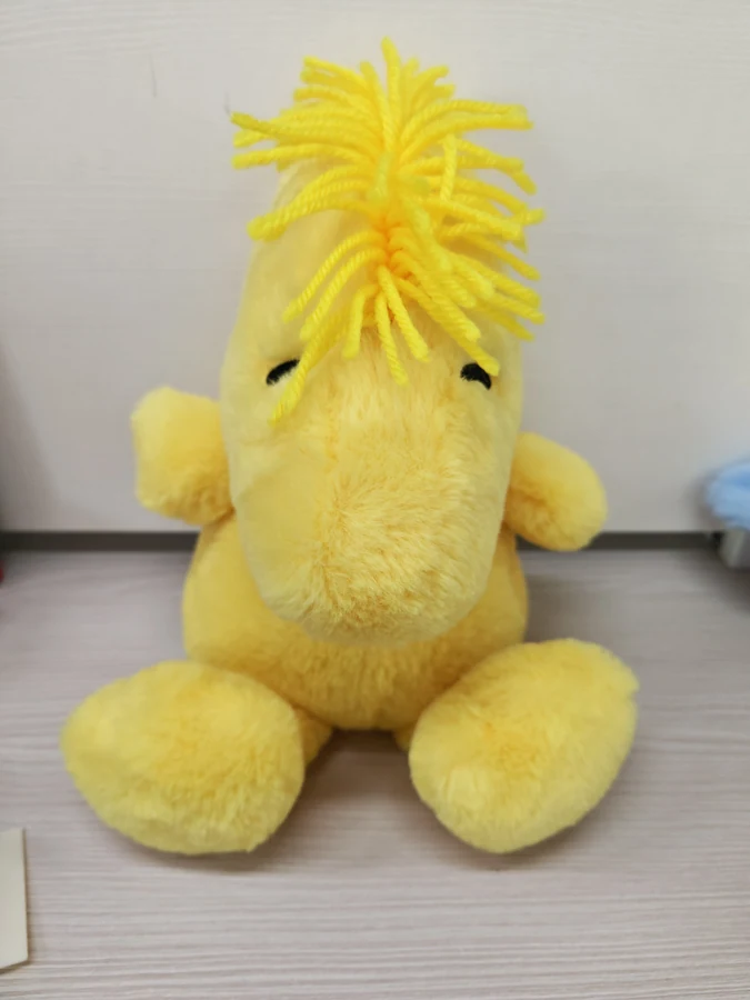 Yellow weighted dinosaur plush